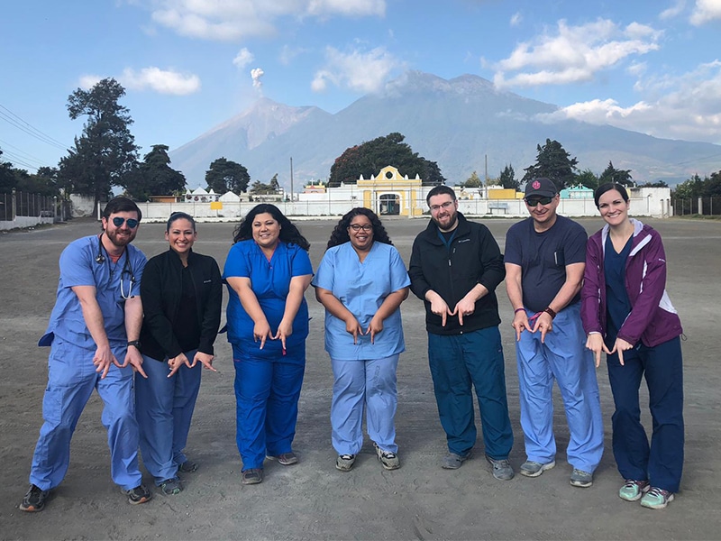 Medical residents in Guatemala make their hands in the shape of an M to support Methodist Health System in Dallas.