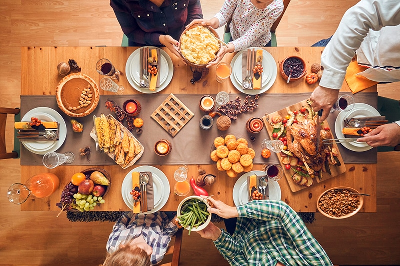 A holiday table with food and family. Cater to all food preferences and allergies with these recipe substitutions.