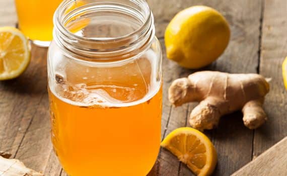 Glass of Kombucha with ginger and lemons; fermented foods may support gut health.