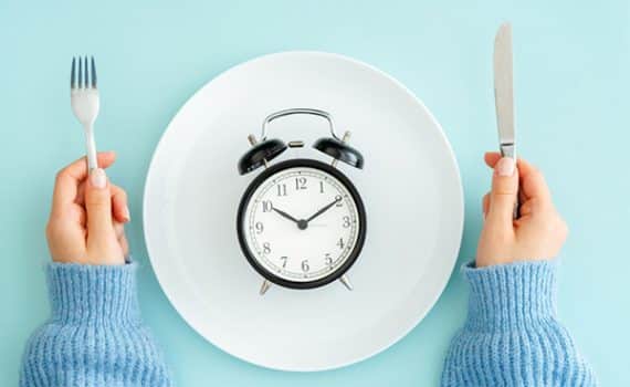 Clock on dinner plate; learn if intermittent fasting is right for you