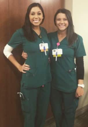 Best friends and nurses fighting COVID-19, Katie Cacioppo and Jessica Pena, side by side in their scrubs.