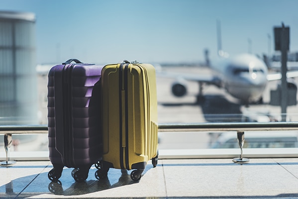 Purple and yellow suitcases in airport terminal