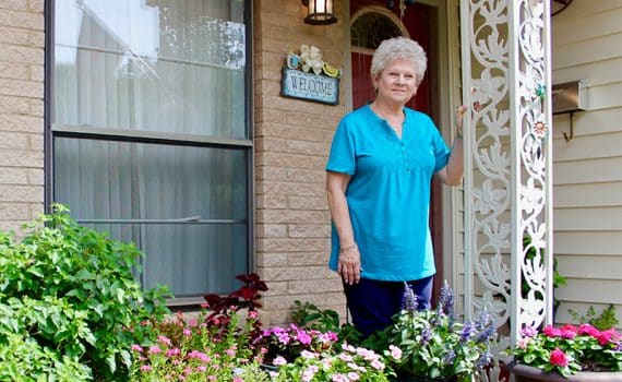 Barbara Niland standing in front of her home after Mako robotic surgery to replace her knee
