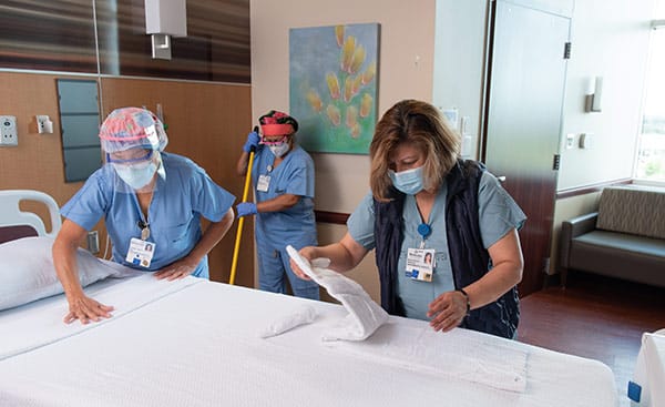 Healthcare heroes Rosa Nyaoga (right), director of environmental services at Methodist Mansfield, leads a team that includes Noelia Toruno (center) and Ledoina Campos.