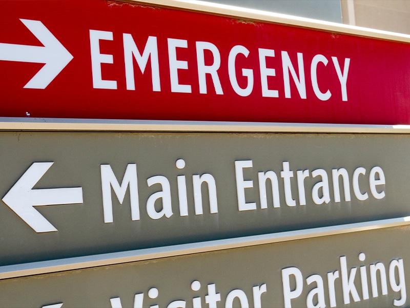 Hospital sign outside emergency rooms with red emergency