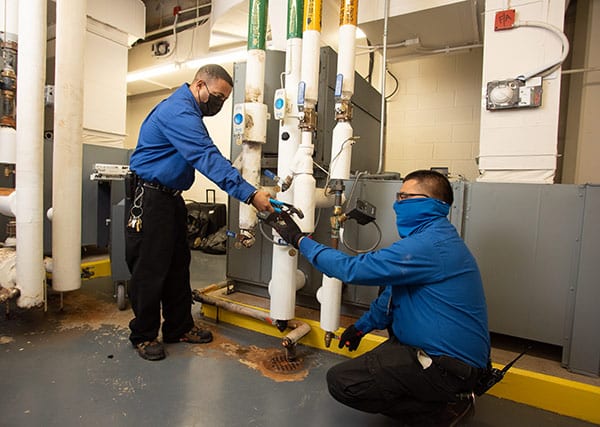 Healthcare heroes and physical Plant technicians Don Turner (left) and Juan Reveles