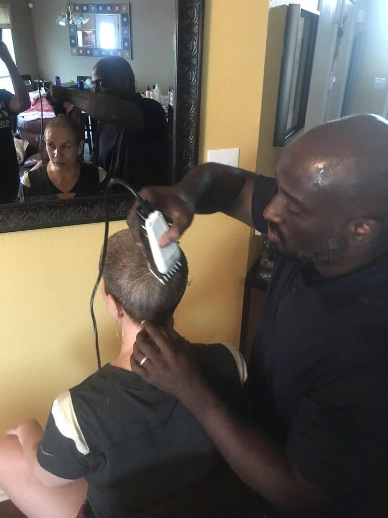 Michelle having her head shaved during breast cancer treatment