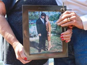 Kathy and Chuck Magers holding a photo from when they were young, after Chuck's treatment of pancreatitis