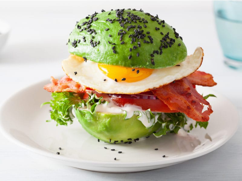 Keto diet friendly burger with avocado halves instead of a bun