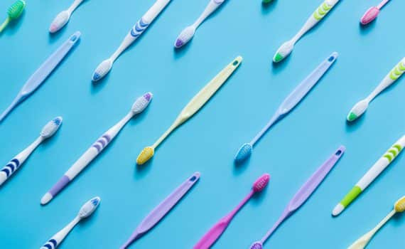 Toothbrushes arranged in diagonal rows, used to represent germs