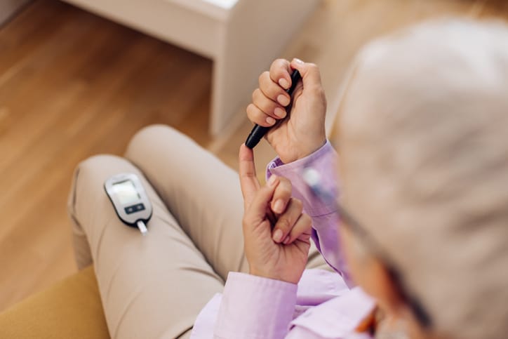 Older person checking their blood sugar