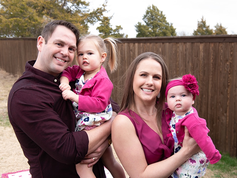 Colton and Samantha Crist with their two daughters after Samantha's newborn was born during a spike in COVID-19 cases.
