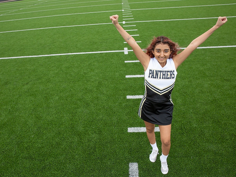 Nadia Gomez photographed cheerleading in her uniform after her liver transplant