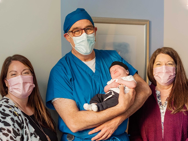 Harold Kolni, MD, with Leslie and her infant, both under the care of the doctor in the NICU