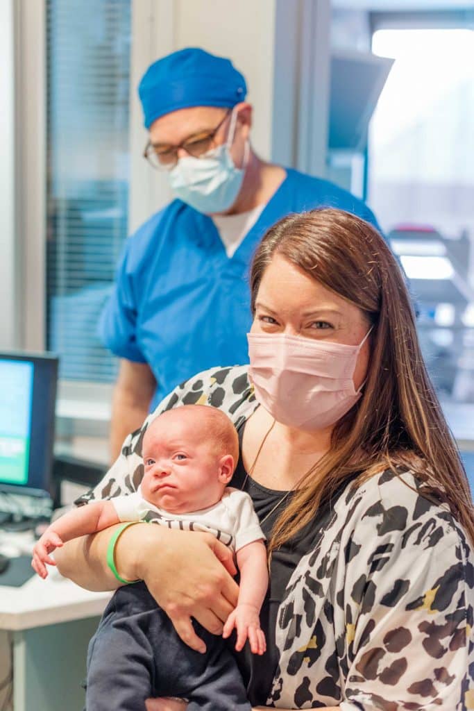 Leslie and baby Ethan, with Dr. Kolni in the background.