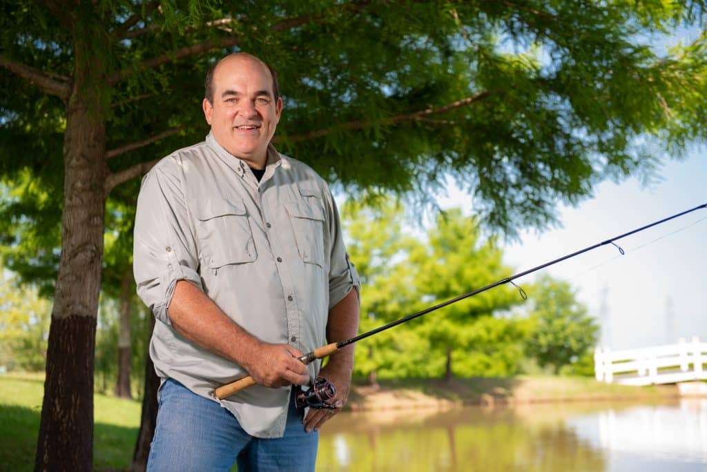 Rich Niccolls after his bout with COVID-19 standing with a fishing rod