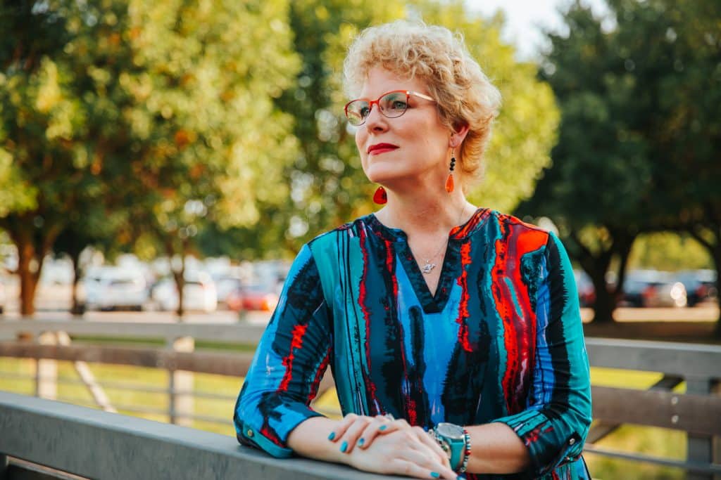 Erika Burkhardt photographed wearing a red, blue, black and green blouse