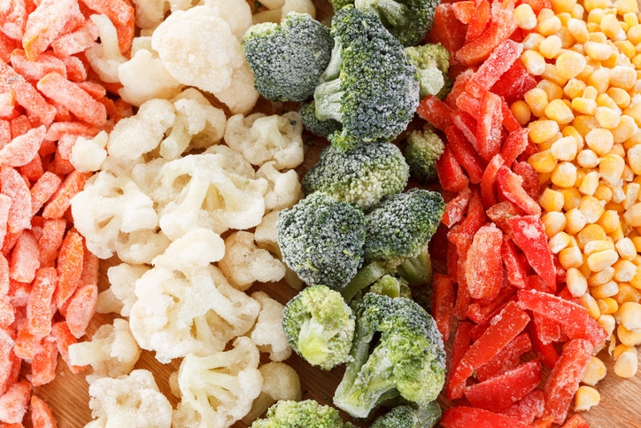 Produce such as cauliflower, broccoli, peppers and corn lined up in rows