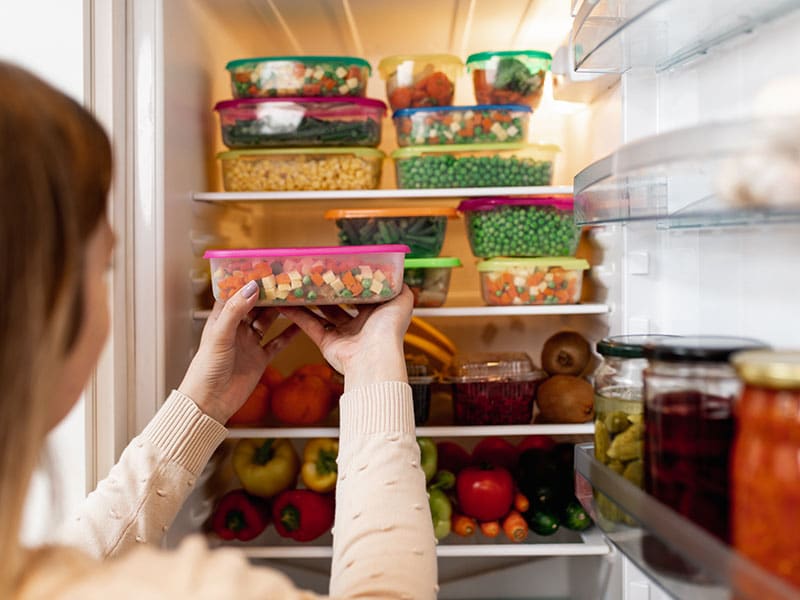 Produce and meals prepped into tupperwares in the refrigerator