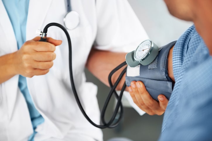 A medical professional checks a patient's blood pressure