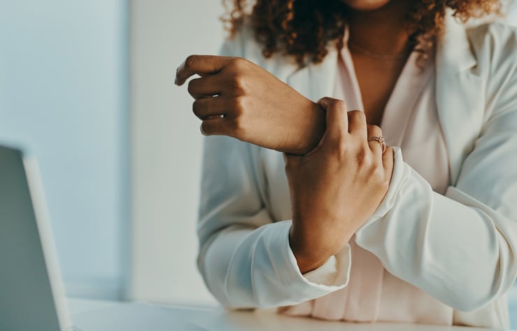 Woman holding her wrist