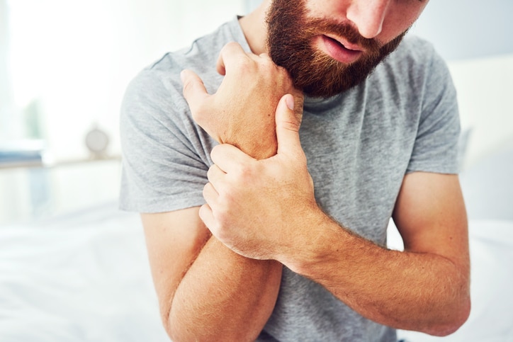 Man grabbing his wrist in pain