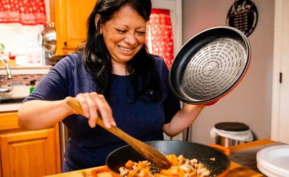 Alice Chapa cooking in the kitchen after her colorectal cancer treatment