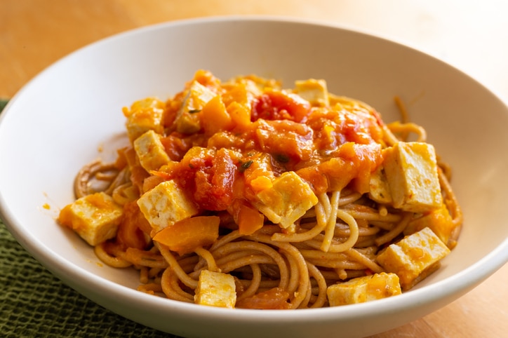 Photograph of tofu, spaghetti, and sauce pasta dish