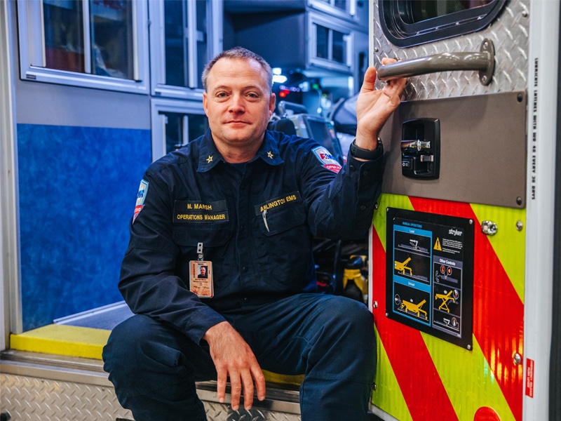 Paramedic and EMS operations manager Michael Marsh sitting in the back of an ambulance looking at the camera after seeking care for a burst appendix