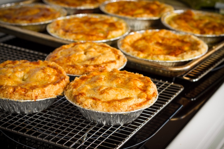 Nine chicken pot pies on cooling racks