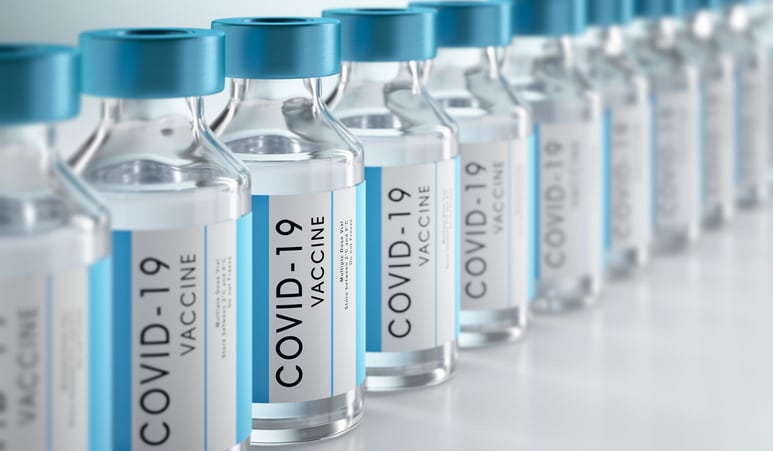 An array of vials that say "COVID-19 Vaccine" on the bottles