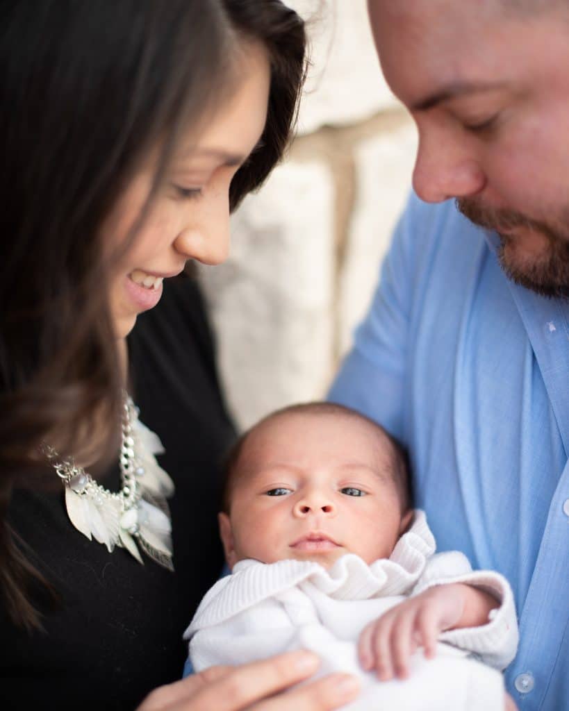 Midlothian residents Daniel and Alyssa McCoy smiling and looking down at their new baby Heidi