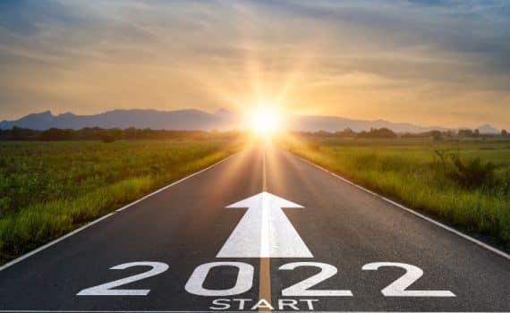 An inspirational photo of a sunset and "2022" written on a road, used to explain new year's resolutions