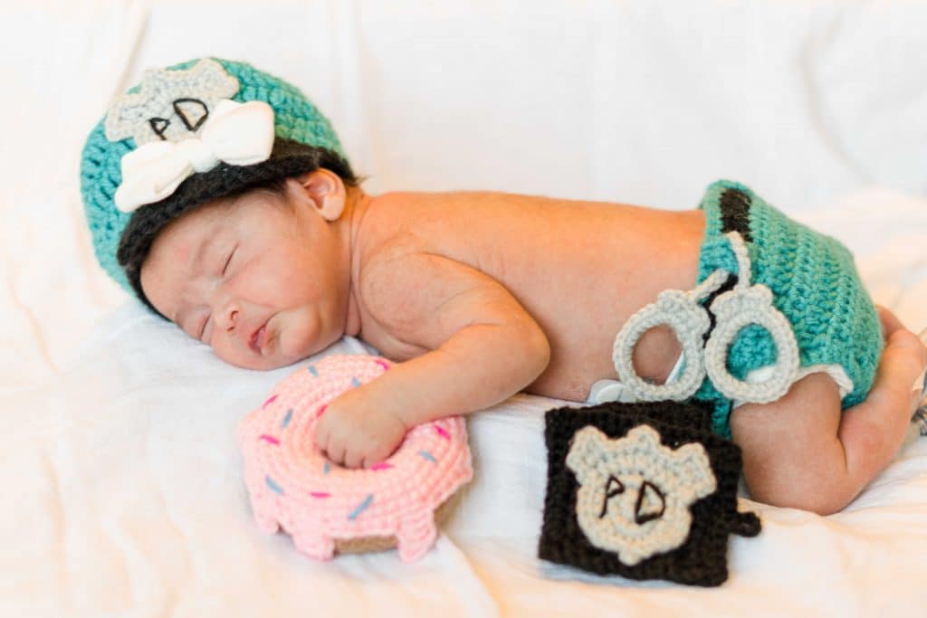 Baby Natalia dressed in a crochet police officer costume 