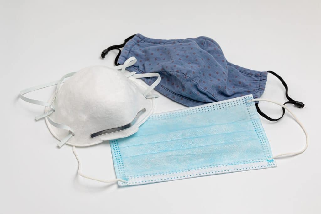 A cloth face mask, a respirator face mask, and a surgical face mask