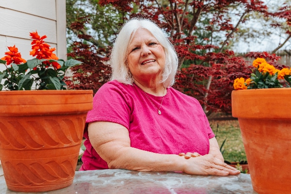 Cyndia Moore photographed in a garden after her stroke