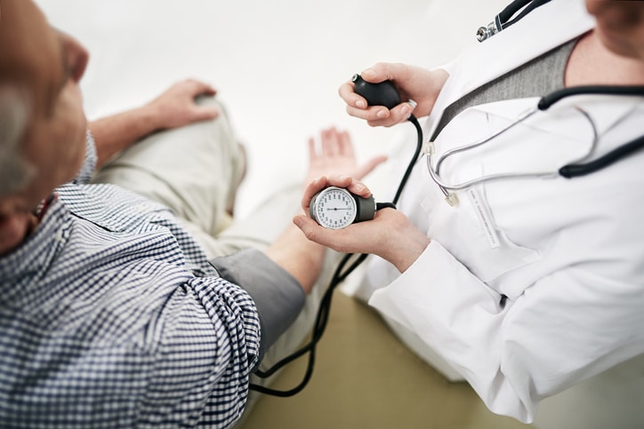 A medical professional measuring the blood pressure of a patient