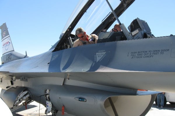 Pilot and crew member work together on a small airplane.