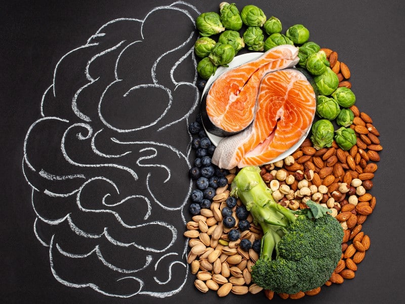 Stock image of food and a chalk outline of a brain, used to explain the MIND diet plan for the brain