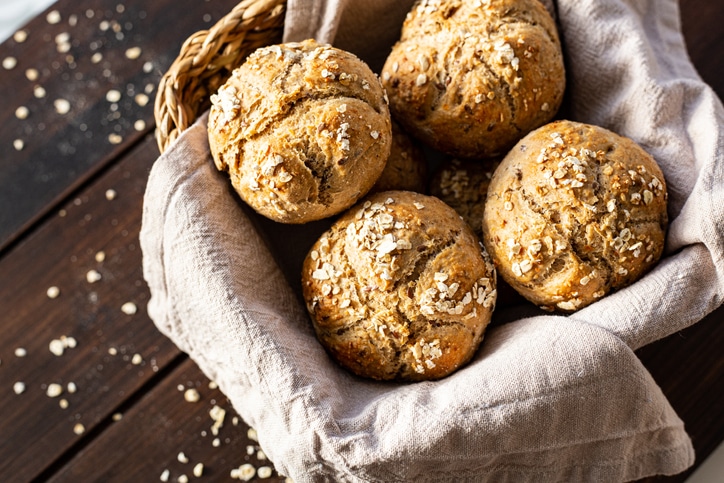 Photograph of bread rolls in a basket with a canvas cloth