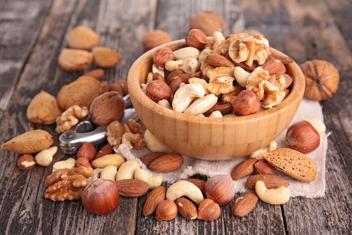 A wooden bowl of assorted nuts