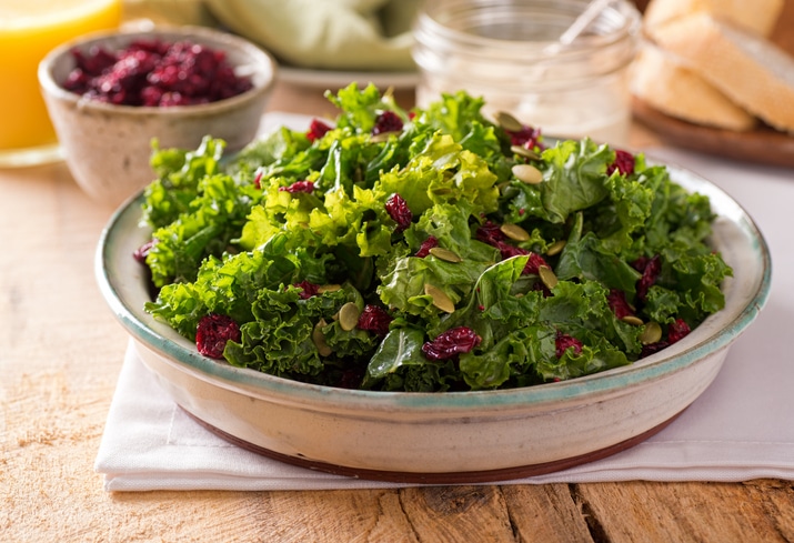 Bowl of a light salad with dried berries and pepita seeds