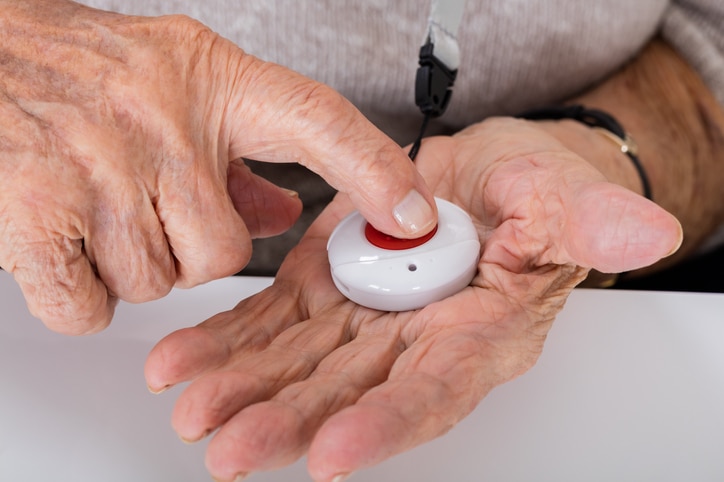 A person pushing down on a medical panic button