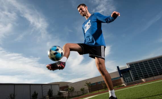Zach Thibodeau kicking a soccer ball, photographed after his treatment for lymphoma