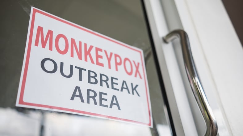 Photograph of a sign that says "monkeypox outbreak area"