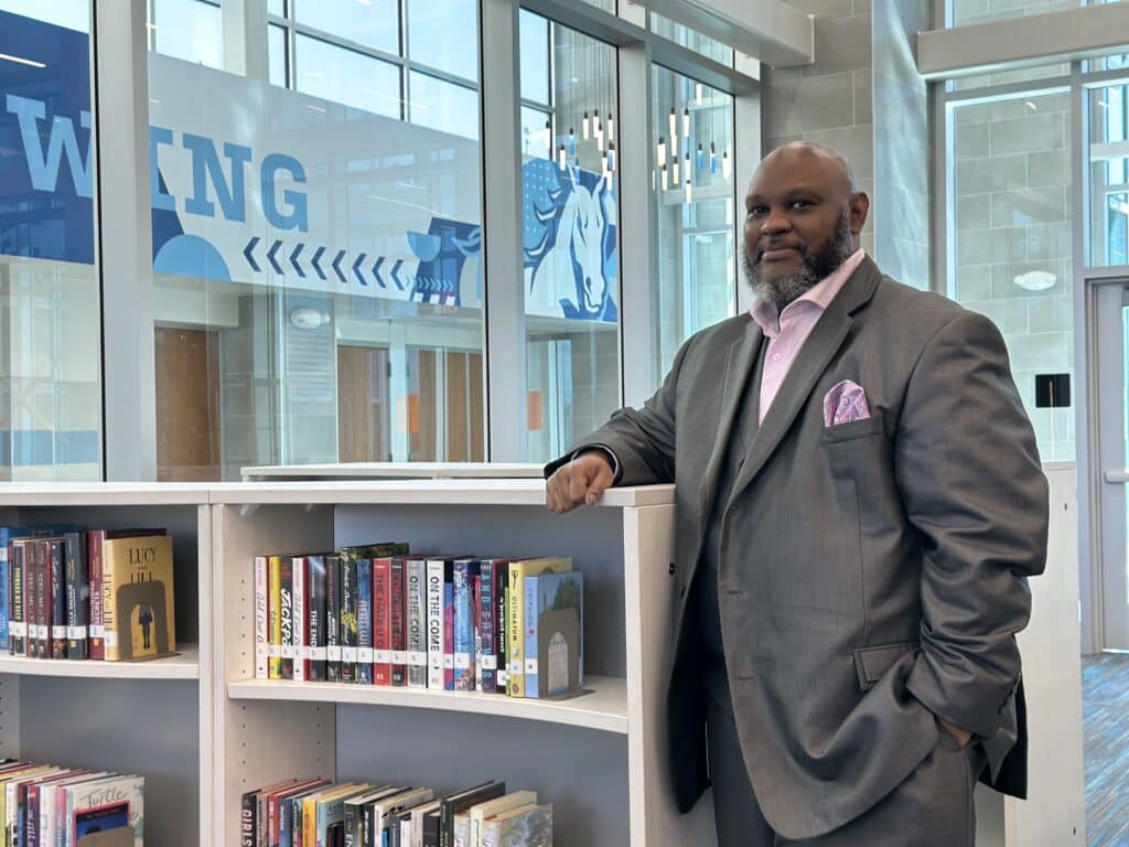 Stephen Terry photographed in a suit and in the school he is an administrator at