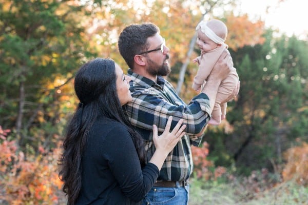 Kaydee Endrody, standing next to her husband Andy, who is holding their baby Ruby