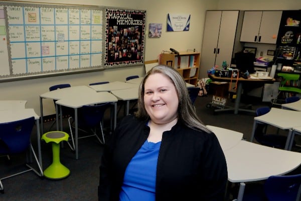 Midlothian educator Megan Lynch smiling at the camera in a classroom