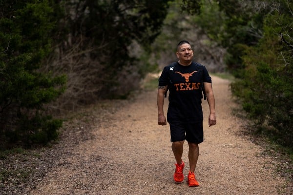 COVID-19 survivor Ray Hernandez photographed with a University of Texas t-shirt
