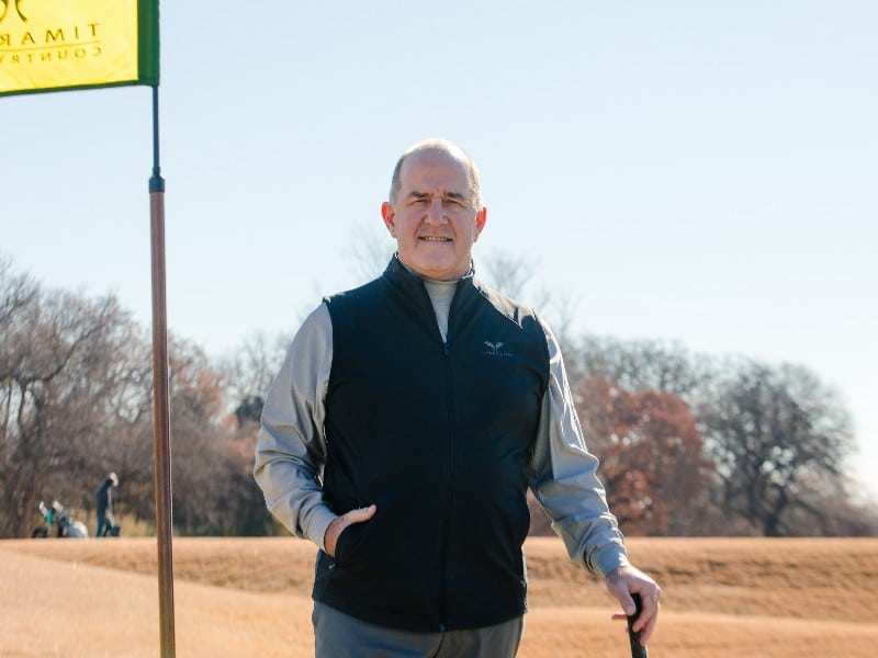 Colleyville resident John Jackson on a golf course in front of a hole and flag, photographed after his pneumonia recovery and treatment at Methodist Southlake Medical Center